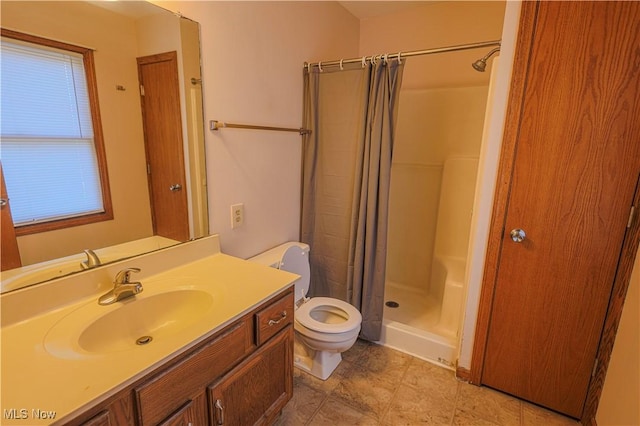 bathroom featuring vanity, toilet, and curtained shower