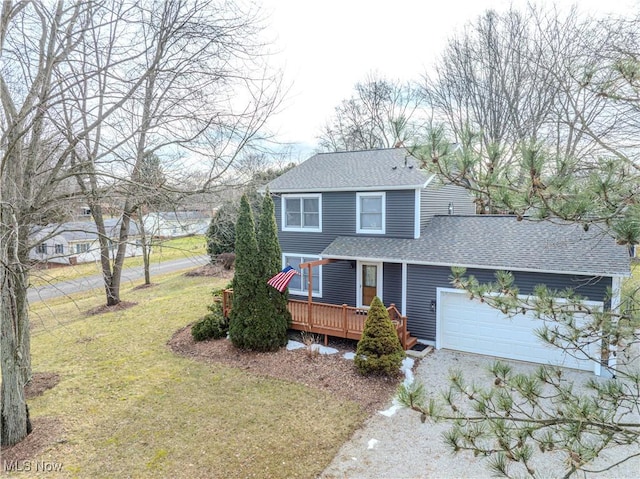 view of front property featuring a garage, a front yard, and a deck