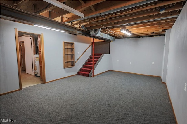 basement featuring gas water heater and carpet flooring