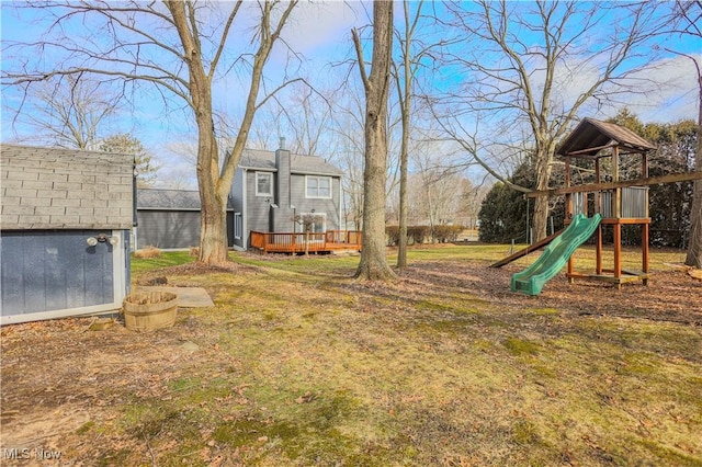 view of yard with a playground and a deck