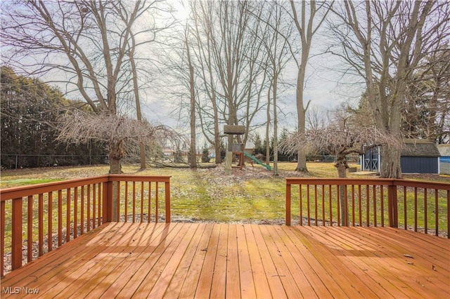 wooden terrace with a playground and a lawn