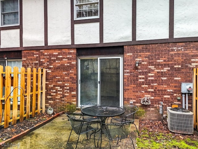 rear view of house with central AC unit