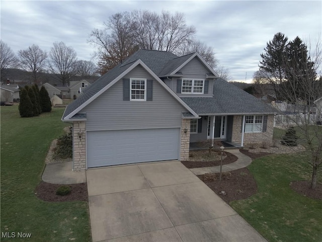 view of front property featuring a garage and a front lawn