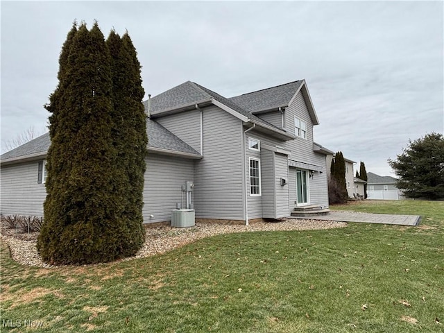 view of side of home with a yard