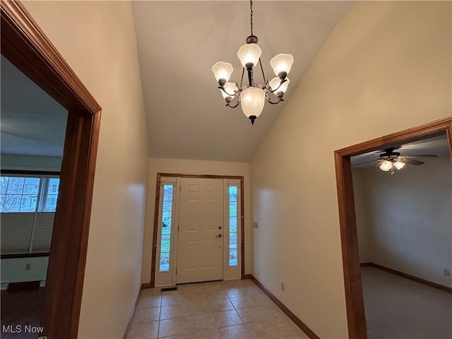 entrance foyer with an inviting chandelier, light tile patterned floors, and high vaulted ceiling