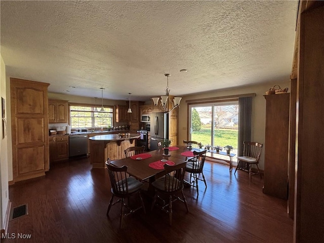 dining room featuring dark hardwood / wood-style flooring and a chandelier