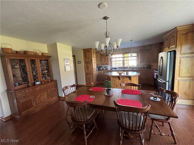 dining space with dark hardwood / wood-style flooring, a chandelier, and a textured ceiling