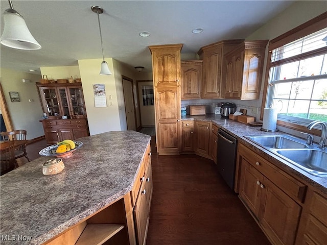 kitchen featuring sink, decorative light fixtures, dark wood-type flooring, and dishwasher