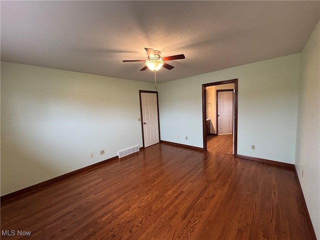 unfurnished room featuring ceiling fan, a textured ceiling, and dark hardwood / wood-style flooring