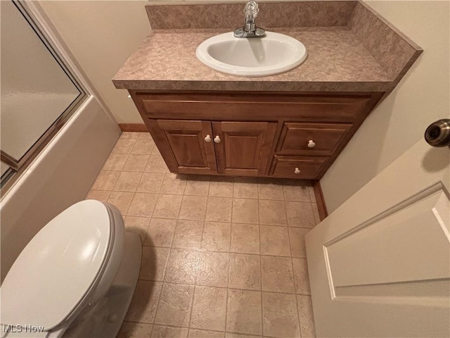 full bathroom featuring vanity, toilet, and combined bath / shower with glass door