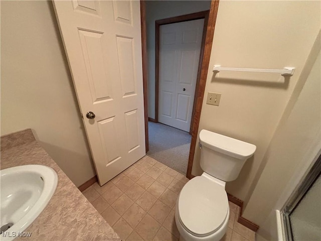 bathroom with tile patterned flooring, vanity, and toilet