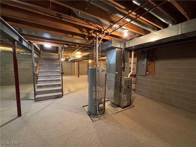 basement with water heater, heating unit, and electric panel