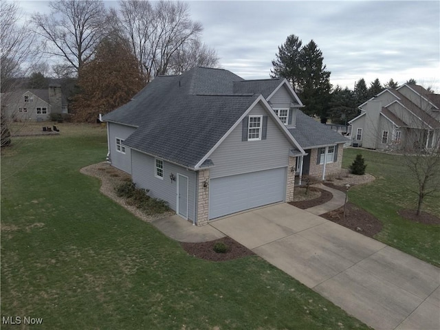 view of front of property with a garage and a front lawn