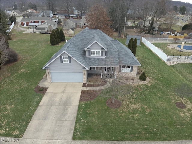 view of front of property with a garage and a front lawn