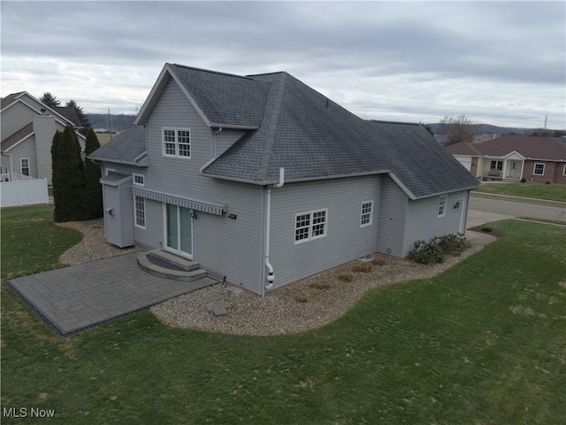 view of side of home with a yard