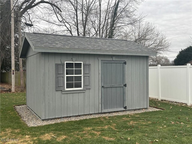 view of outbuilding with a yard