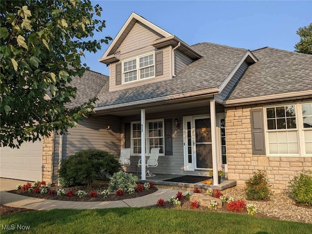 view of front of house featuring a porch and a garage