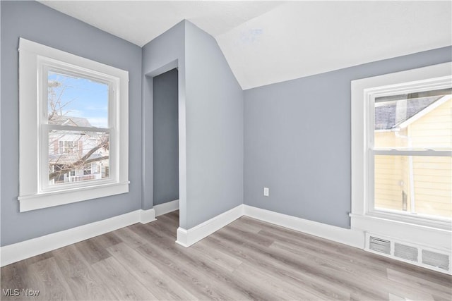 bonus room featuring vaulted ceiling and light hardwood / wood-style flooring