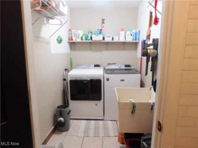 laundry area with light tile patterned flooring, sink, and washer and dryer