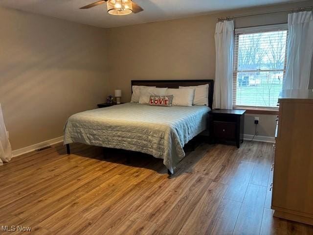 bedroom featuring hardwood / wood-style flooring and ceiling fan