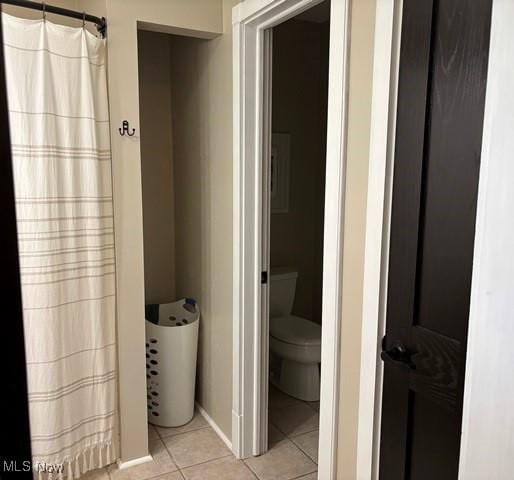 bathroom featuring tile patterned floors and toilet