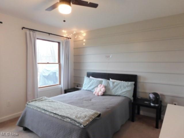 bedroom with light carpet and ceiling fan