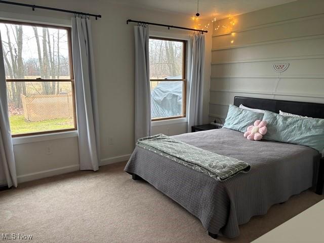 bedroom featuring light colored carpet