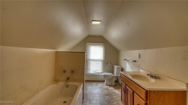 bathroom with lofted ceiling, a tub to relax in, toilet, and vanity