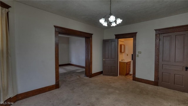 unfurnished bedroom featuring light carpet, a notable chandelier, and a textured ceiling