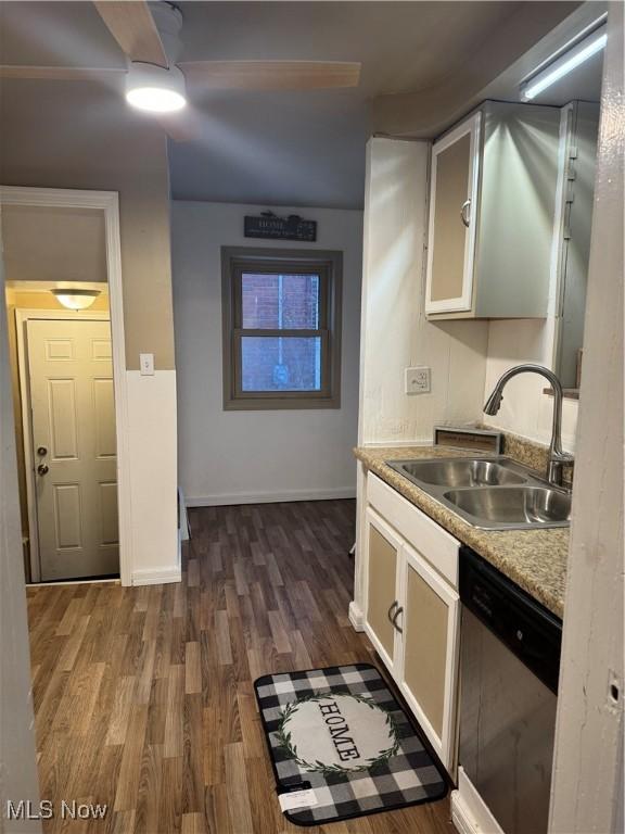 kitchen with dark hardwood / wood-style flooring, dishwasher, and sink