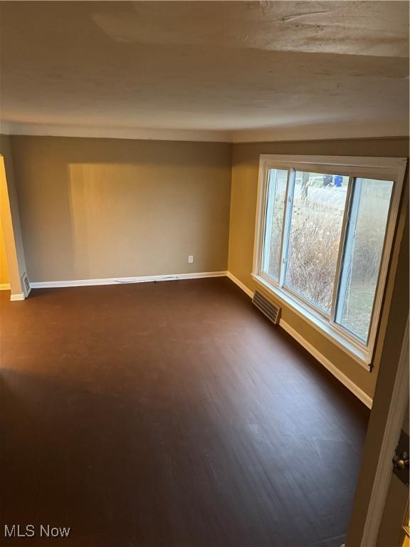 spare room featuring dark hardwood / wood-style flooring