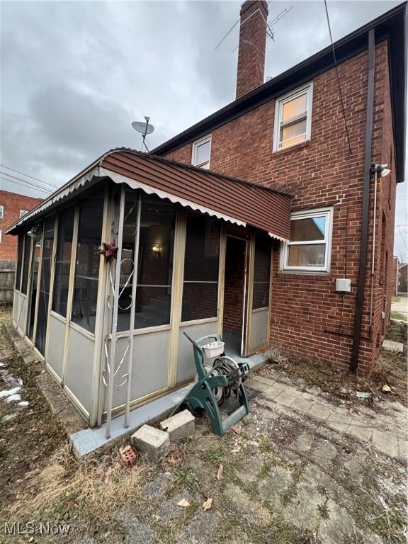 back of property featuring a sunroom