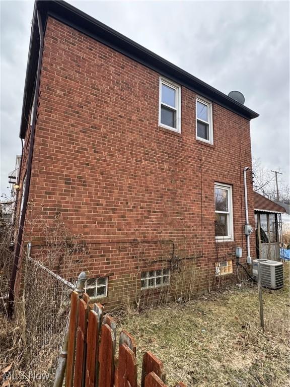 view of side of home featuring central AC