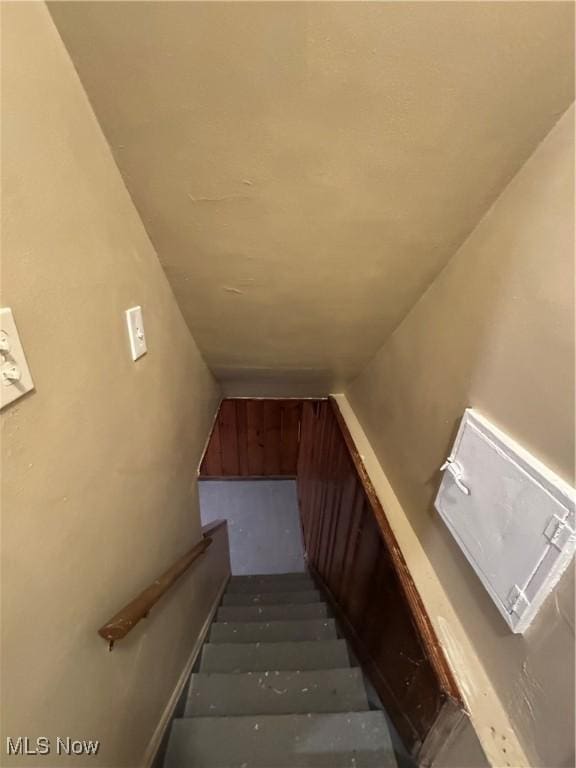 stairway with vaulted ceiling