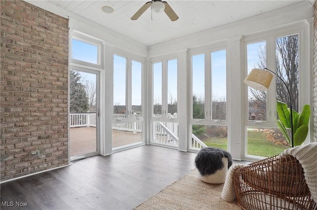 sunroom / solarium featuring ceiling fan