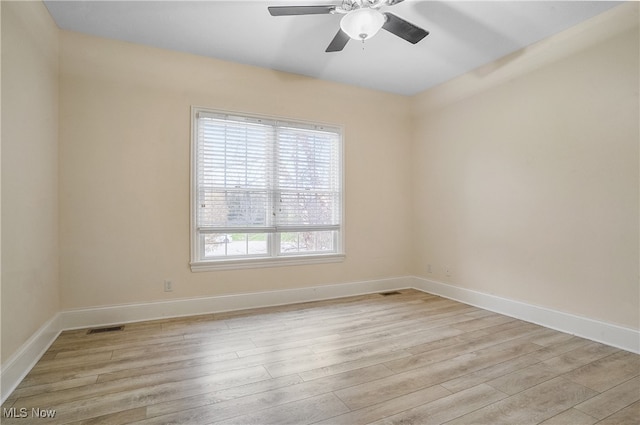 unfurnished room with ceiling fan and light wood-type flooring