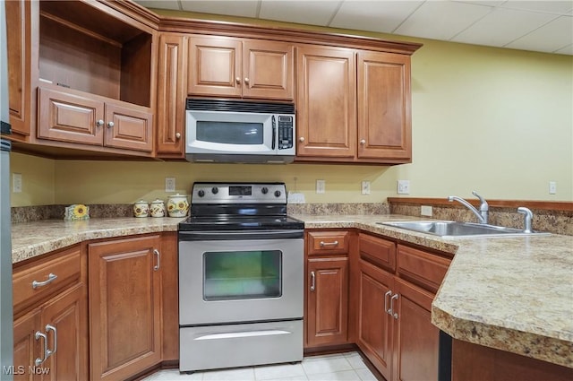 kitchen featuring sink, light tile patterned floors, and appliances with stainless steel finishes