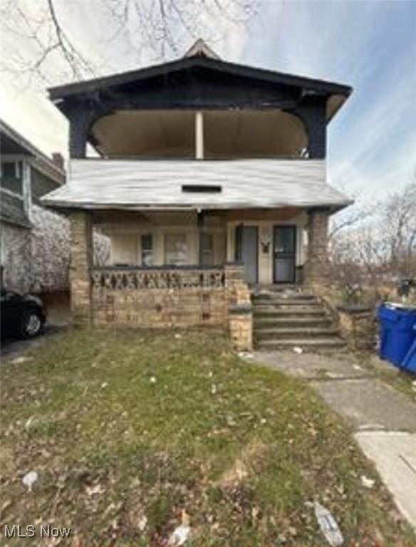 view of front of house with a front lawn and covered porch