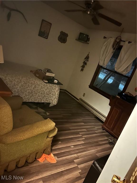 interior space featuring hardwood / wood-style flooring, a baseboard heating unit, and ceiling fan