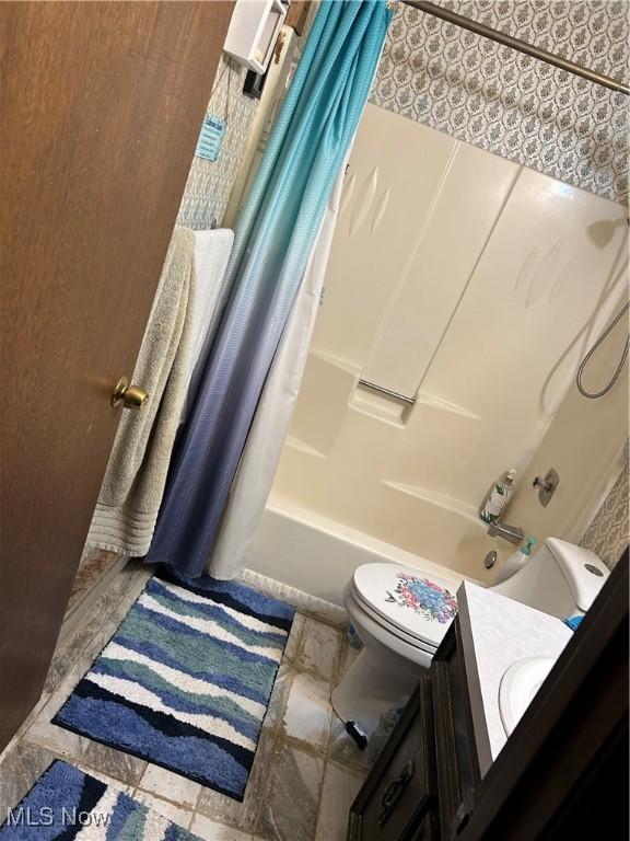 bathroom with shower / tub combo and vanity