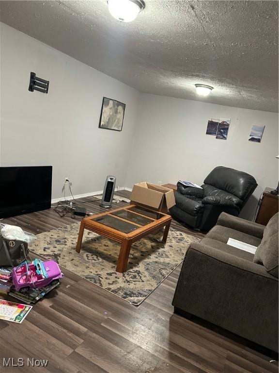 living room featuring hardwood / wood-style flooring and a textured ceiling