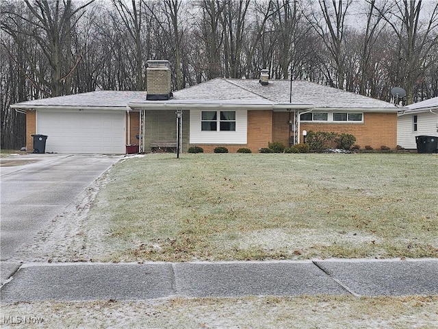 ranch-style home featuring a garage and a front lawn