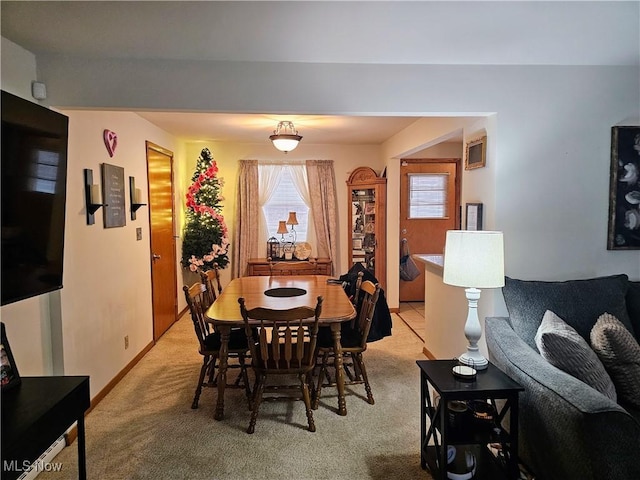 dining area featuring light colored carpet