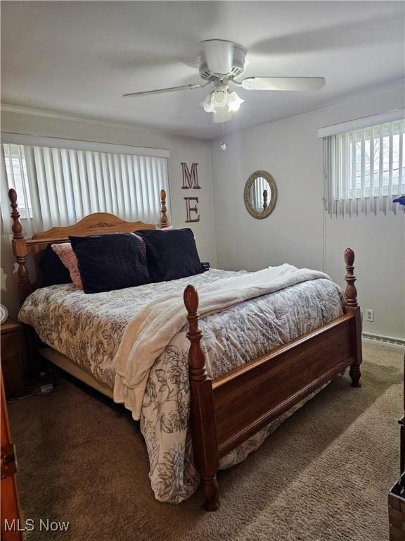 bedroom with ceiling fan and dark colored carpet