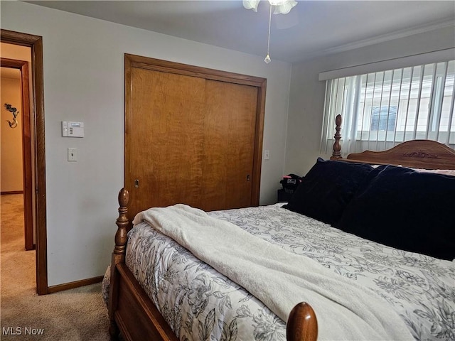 bedroom featuring a closet and light carpet