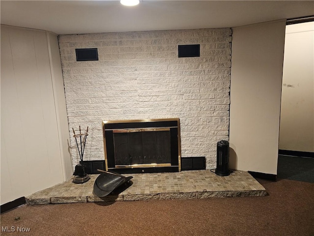 interior details featuring carpet and a brick fireplace