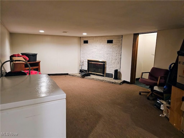 living room featuring a large fireplace and carpet flooring