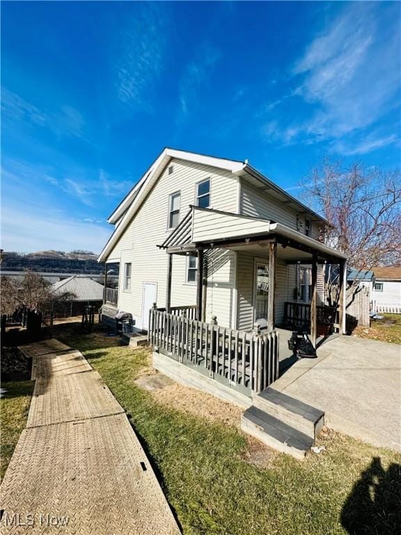 exterior space featuring a porch and a yard