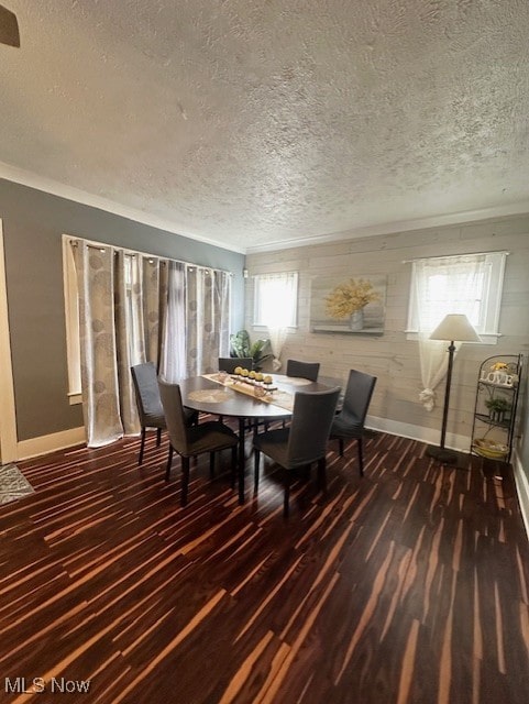 dining space with dark hardwood / wood-style floors and a textured ceiling