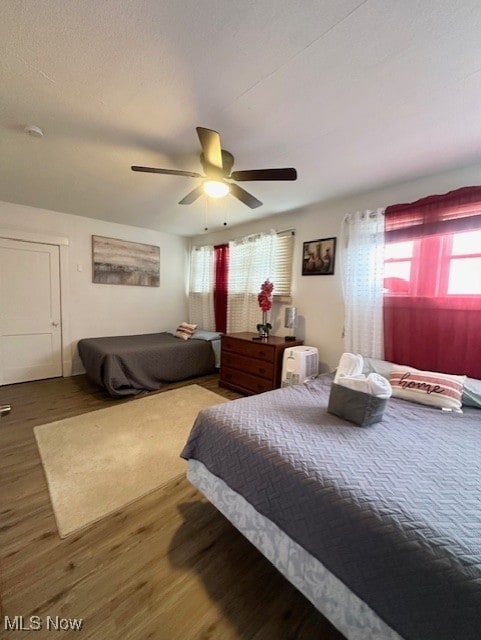 bedroom with hardwood / wood-style flooring and ceiling fan